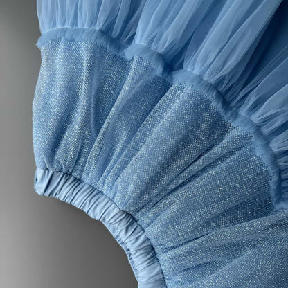 Close-up detail of blue glitter tulle skirt fabric for girls with soft sparkling layers and tulle texture