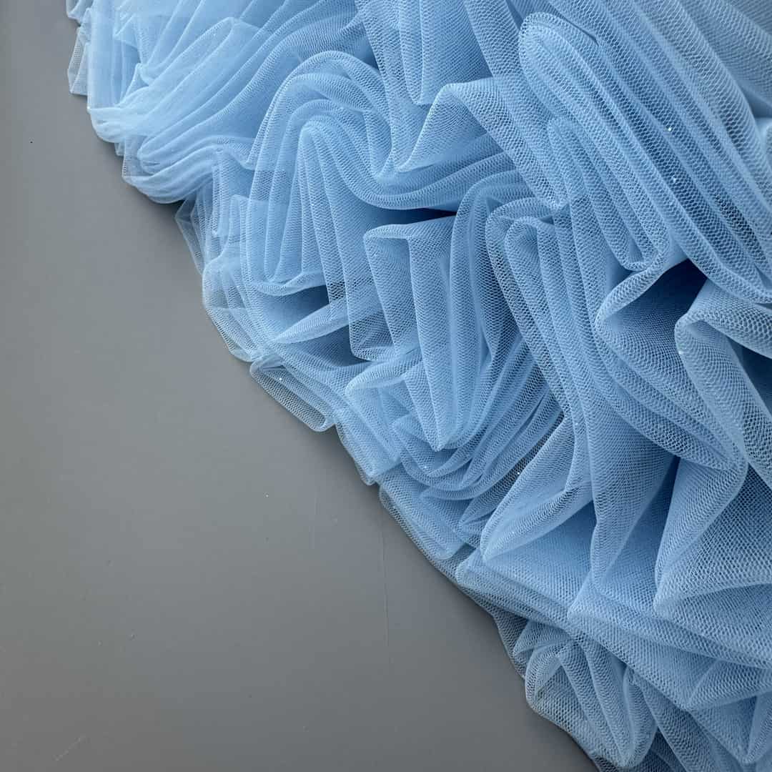 Close-up detail of blue tulle skirt showing volume and layered fabric structure – handmade festive skirt for girls