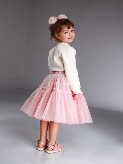 Girl wearing blush pink glitter tulle skirt with cozy sweatshirt – handmade festive outfit for toddlers