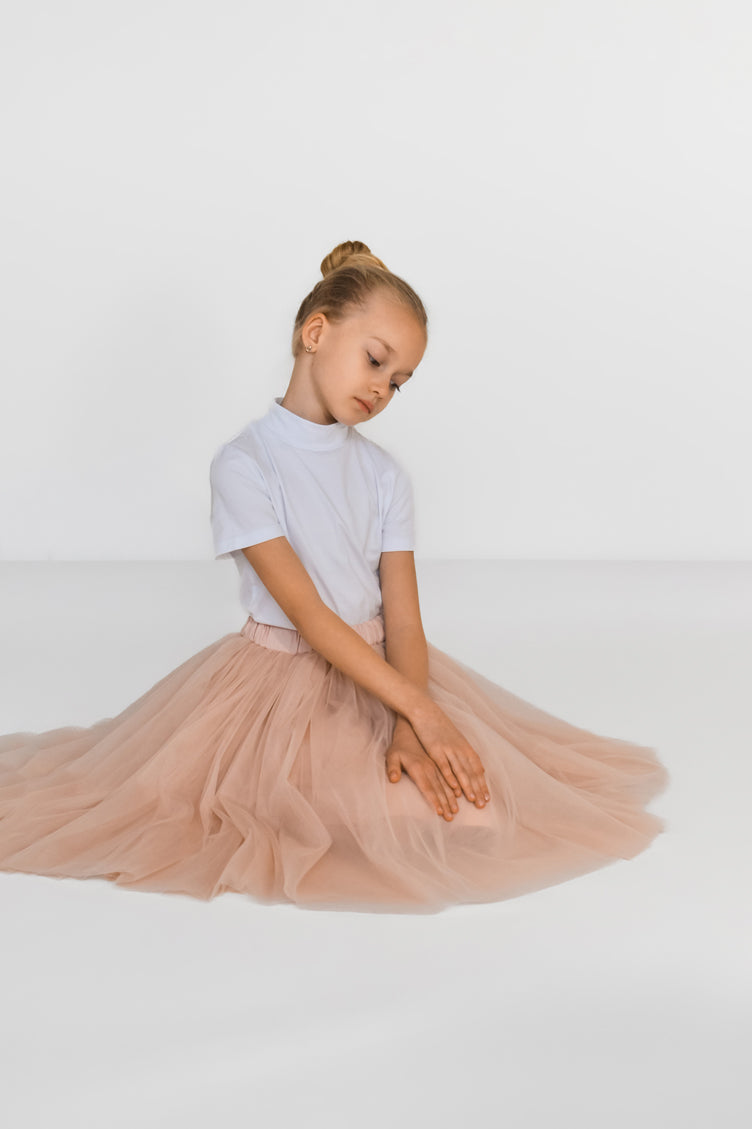 Girl wearing blush pink tulle skirt sitting – elegant handmade outfit for girls