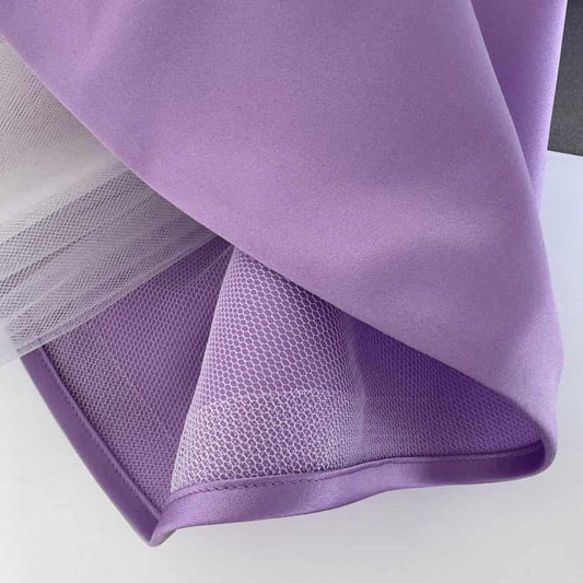 Fine crinoline used in satin dress skirt to create soft volume and shape