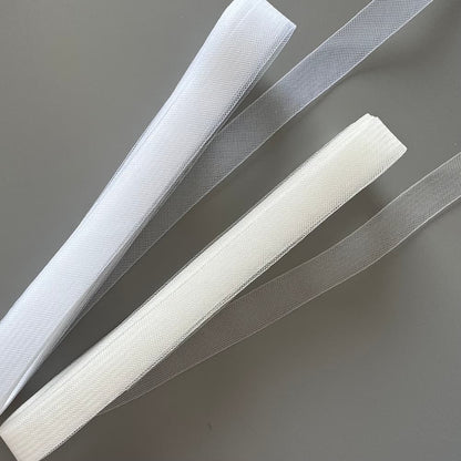 Comparison of fine crinoline in white and transparent showing different colors of dressmaking net band