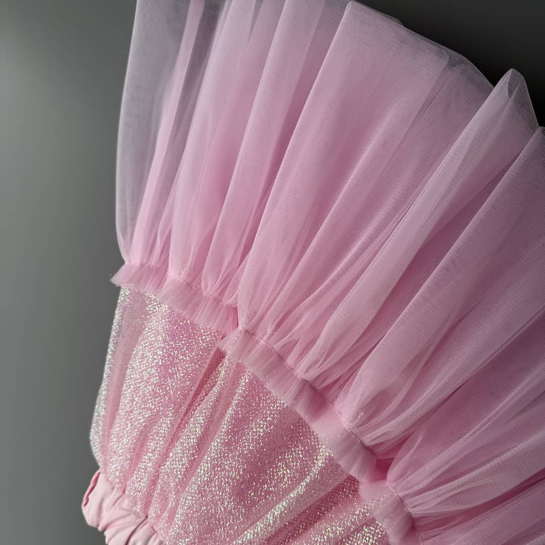 Close-up detail of pink glitter tulle skirt fabric for girls with soft sparkling layers