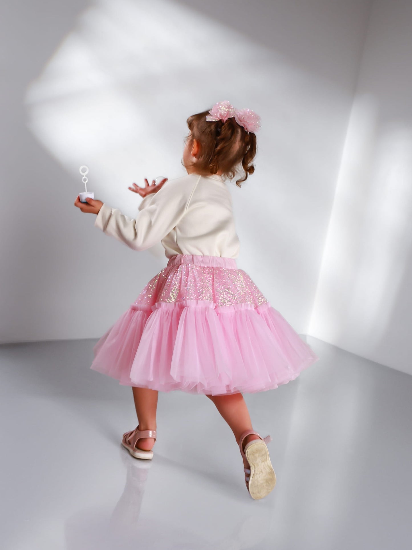 Back view of girl wearing pink glitter tulle skirt – elegant handmade tutu skirt for toddlers