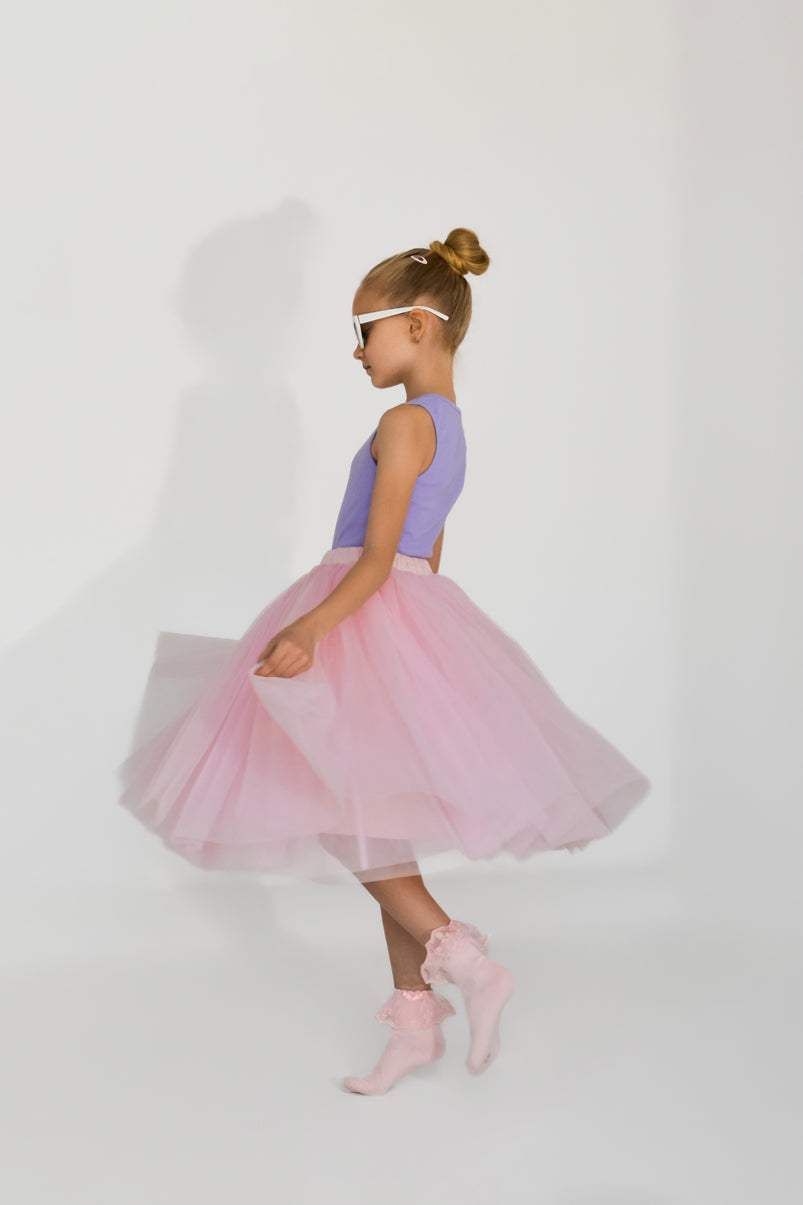 Girl wearing pink tulle skirt showing elegant movement and volume